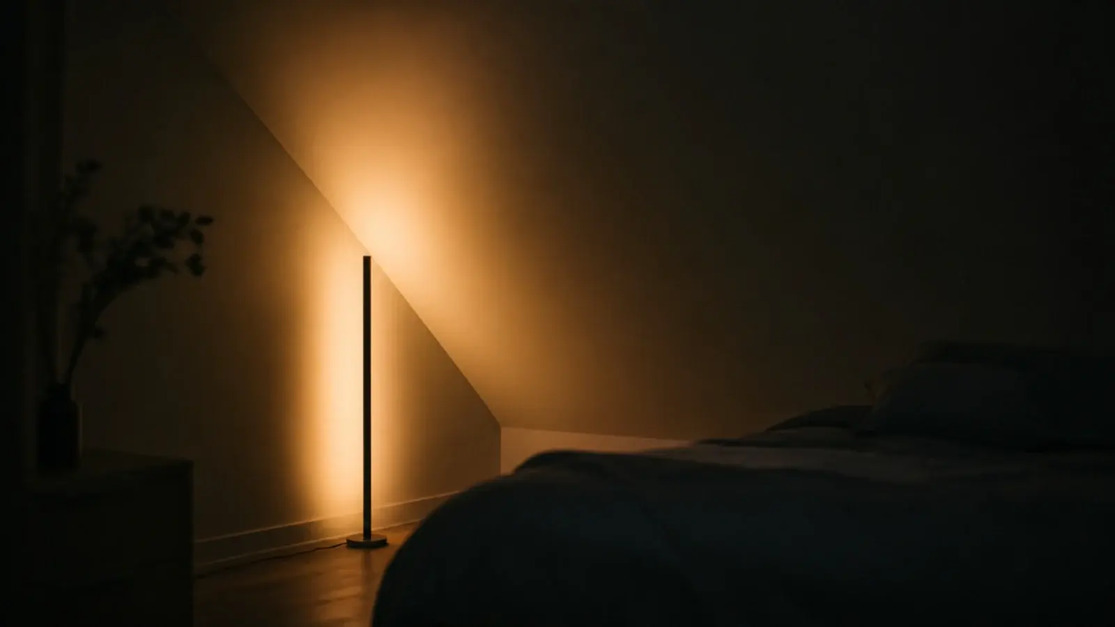 floor lamp aimed upward washing soft light across an attic slope