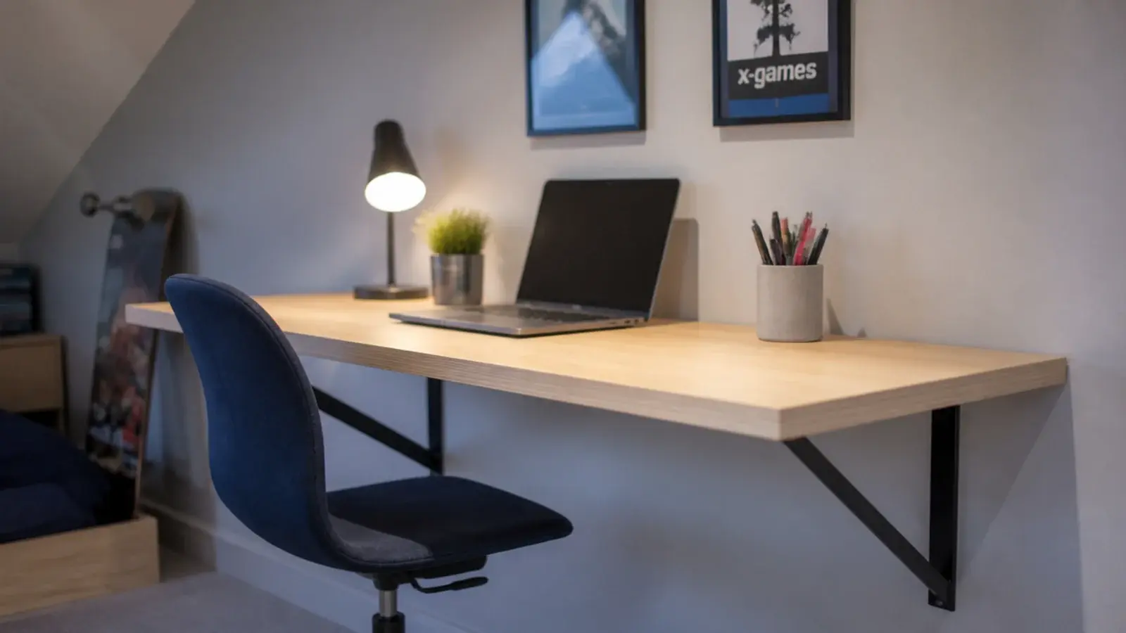plywood desk top fixed to an attic wall on simple steel brackets