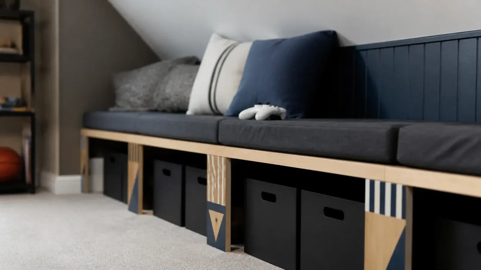 plywood bench running along a boys attic knee wall with storage under
