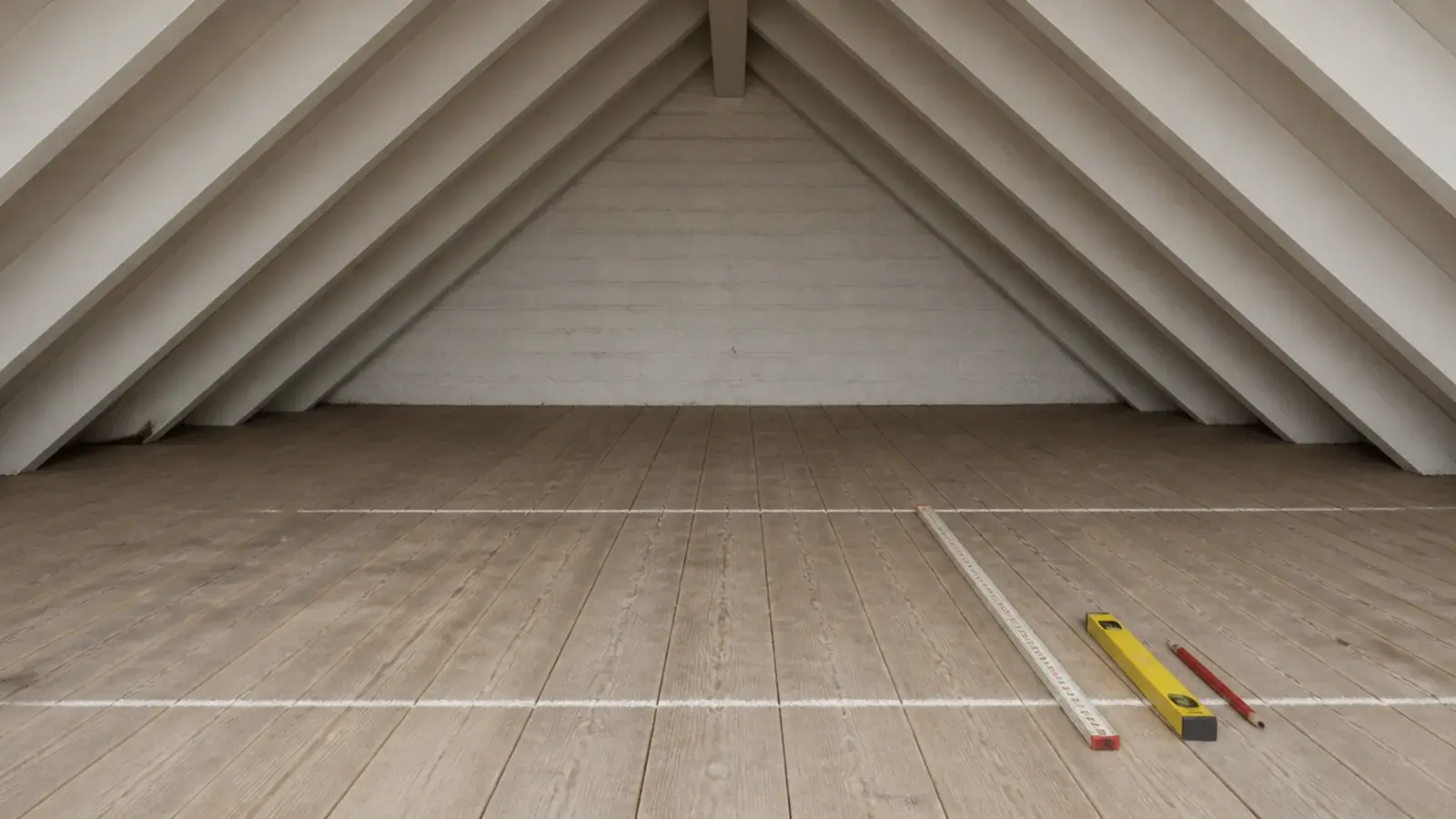 chalk marks on attic floorboards showing five foot and seven foot ceiling lines