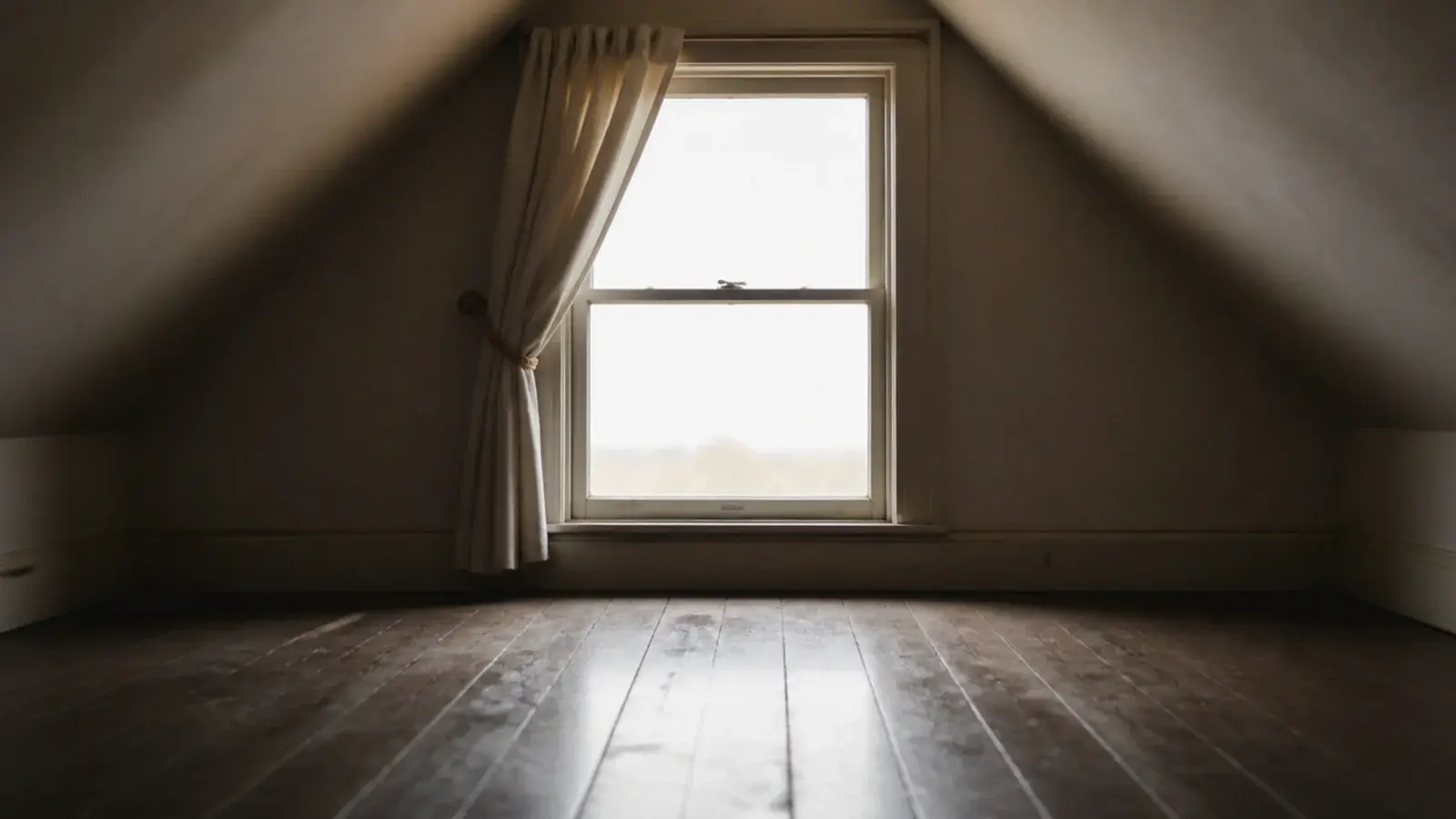 unobstructed escape window in a small attic with empty floor beneath