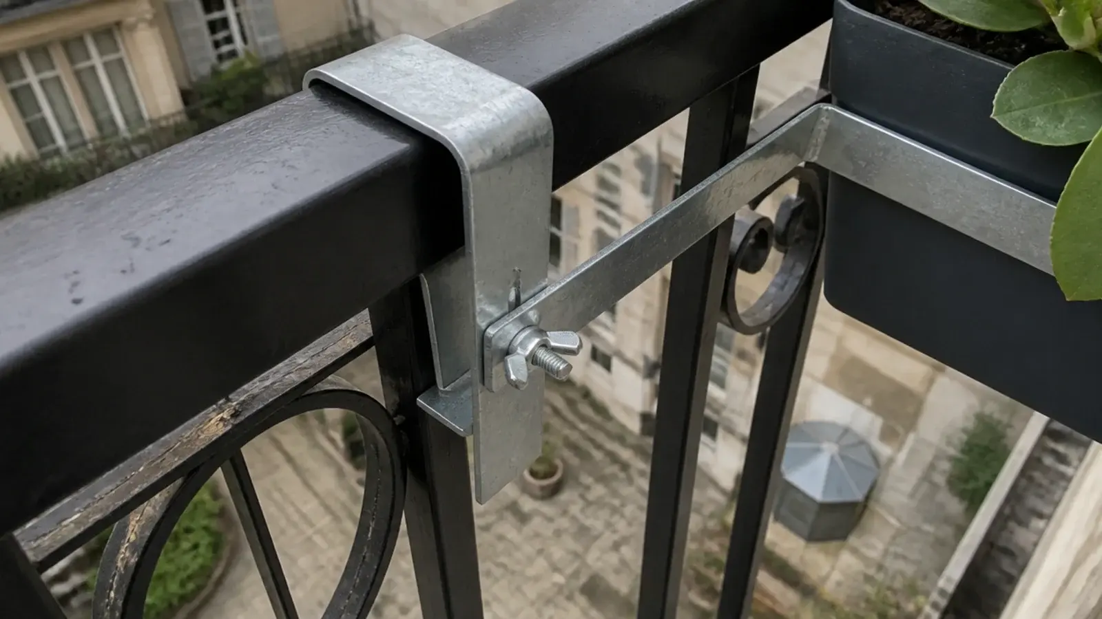 planter bracket hooked over the outside face of a balcony railing