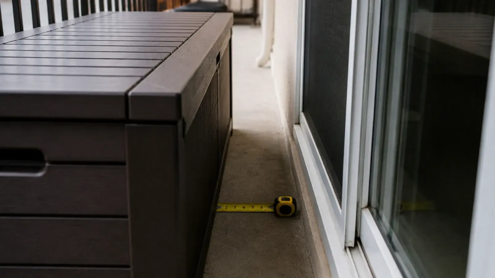 storage bench narrowing the walkway beside a balcony sliding door