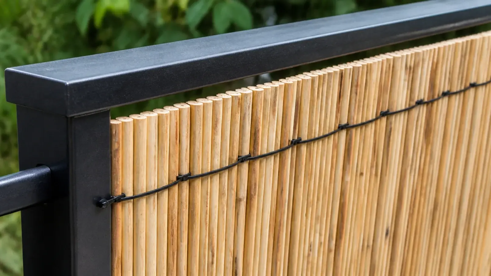 trimmed reed screen fitted inside one section of balcony railing