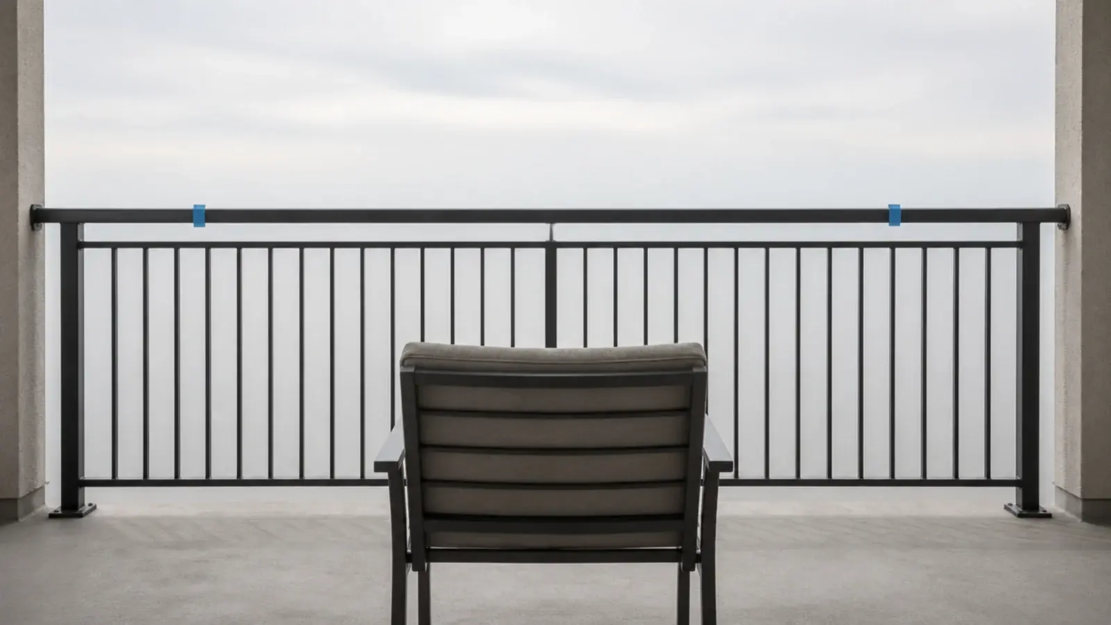 chair placed at a balcony rail with tape marking the exposed section