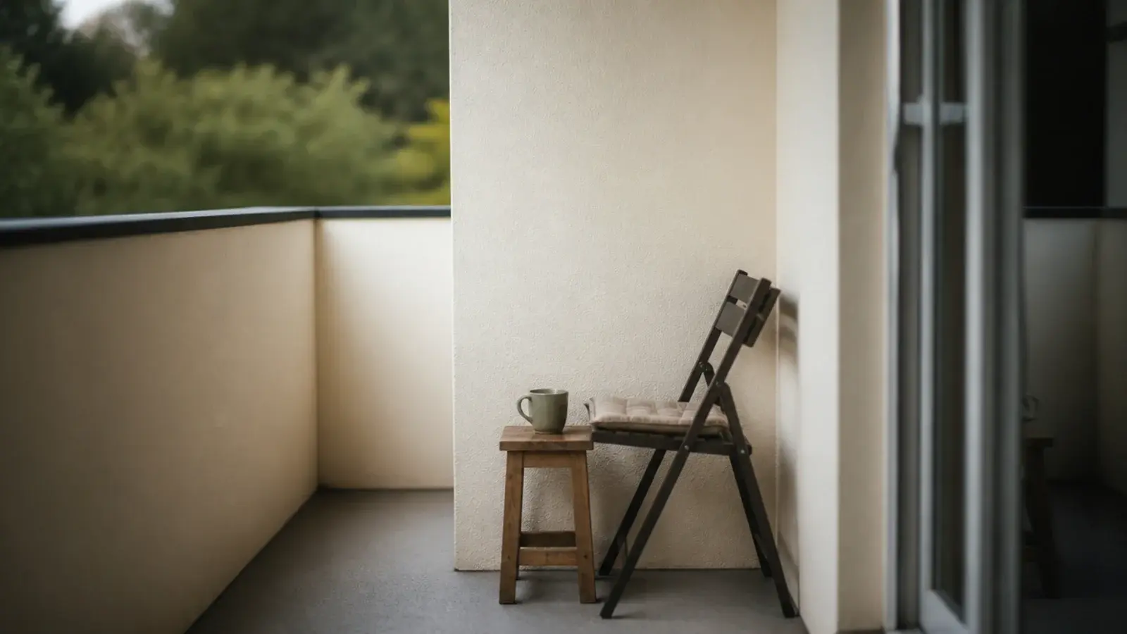 balcony chair repositioned against the building wall for privacy