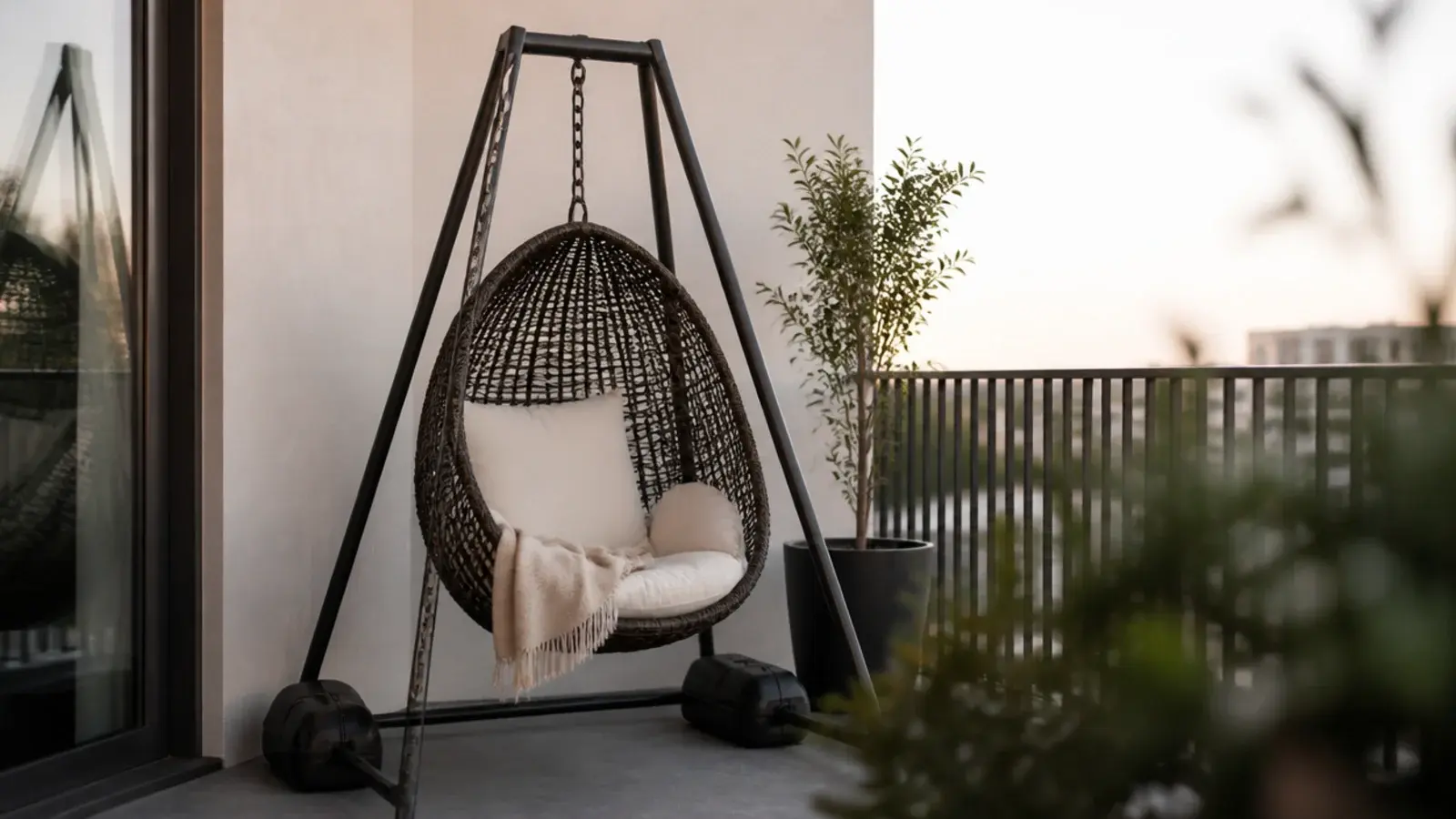 hanging chair on a weighted freestanding frame on a balcony