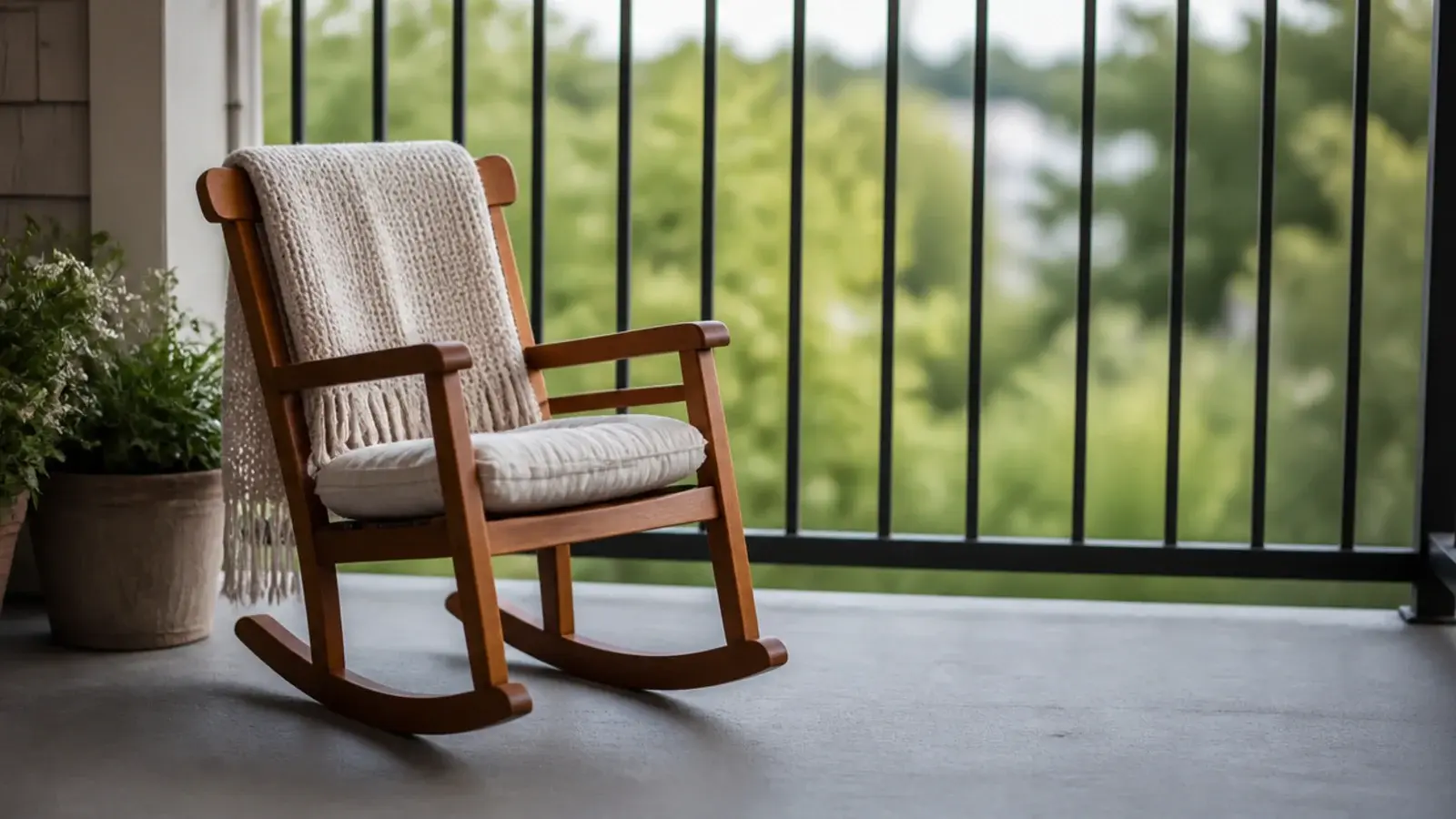 small outdoor rocking chair with clear space behind it on a balcony