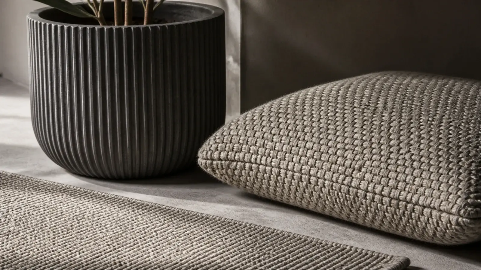 ribbed planter boucle cushion and flatweave rug in one neutral palette