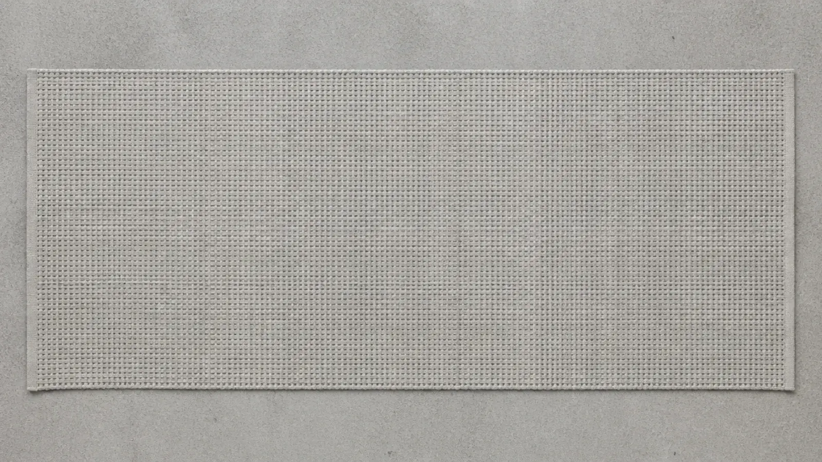 grey toned flatweave runner blending into a concrete balcony floor