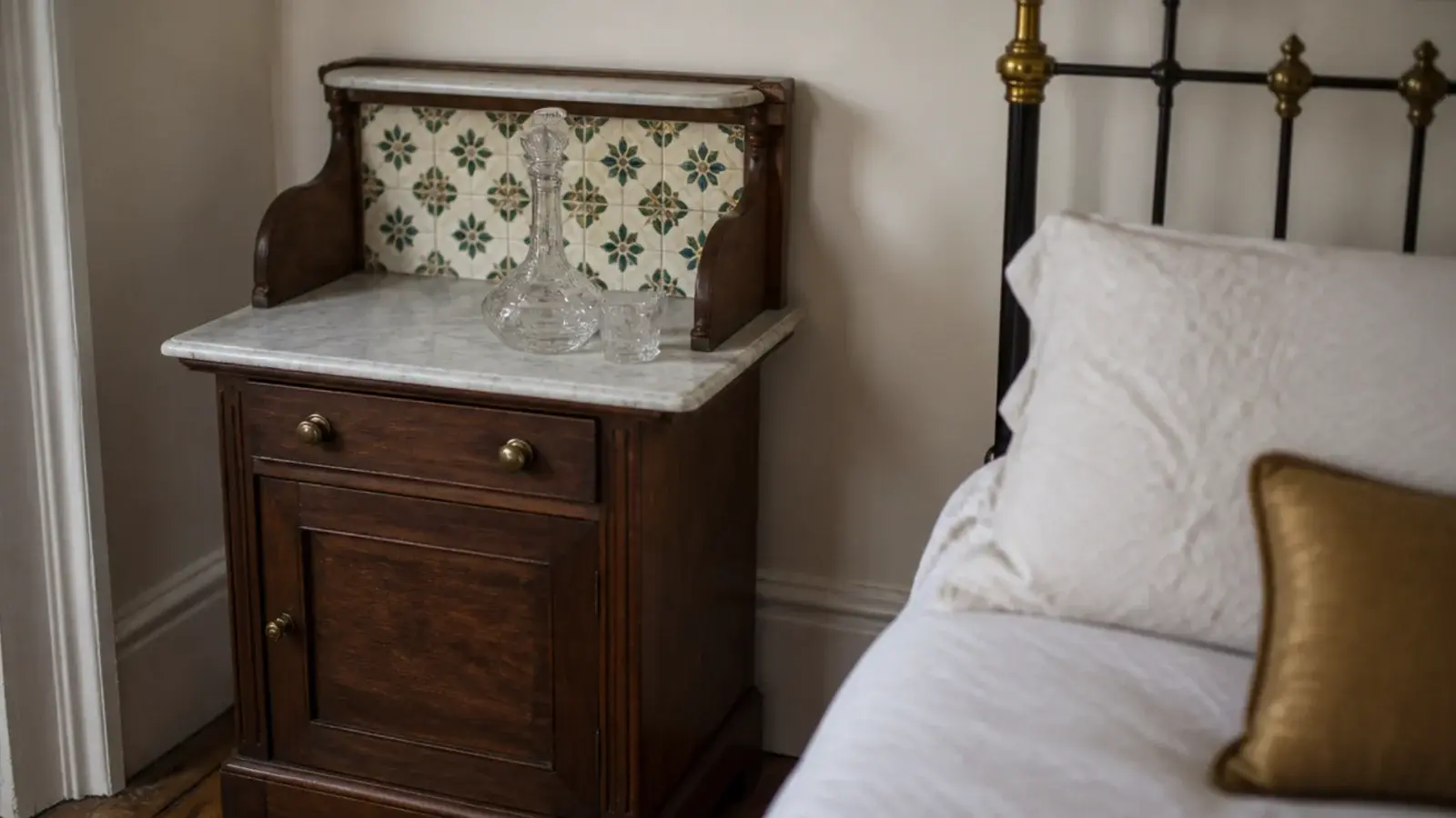 small tiled washstand with a marble top used beside a bed