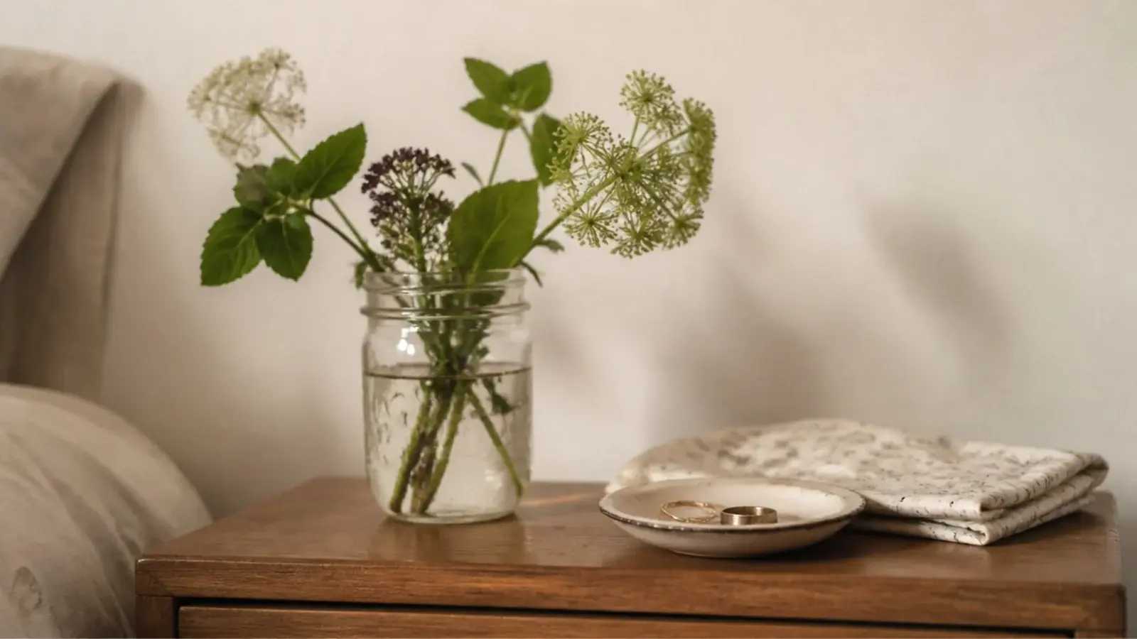 budget bedside table decor ideas using a jar of cuttings and thrifted dish