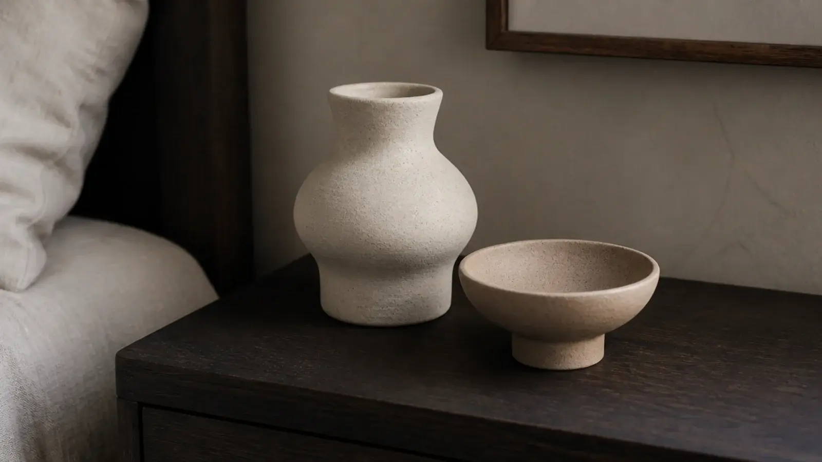 unglazed matte ceramic beaker and dish grouped on a wooden top