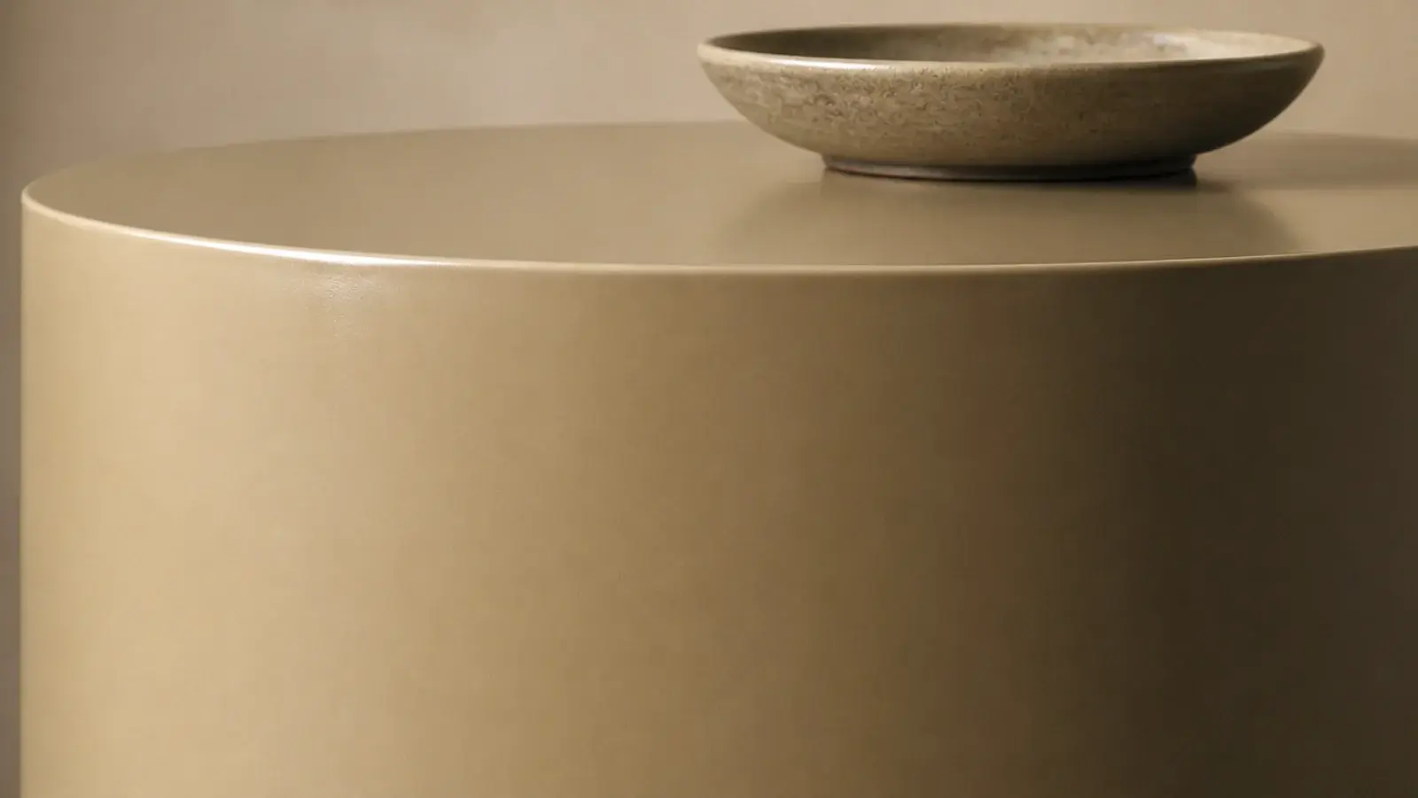 cylindrical drum side table with a continuous unbroken outer surface