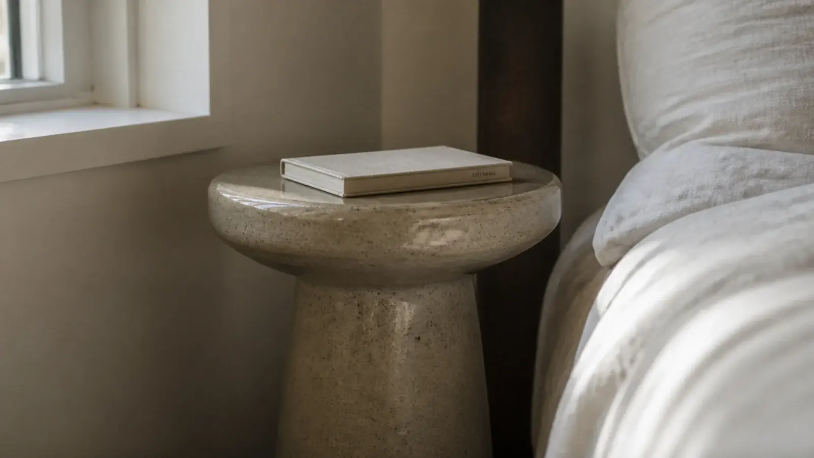 glazed stoneware pedestal table with a soft speckled matte surface