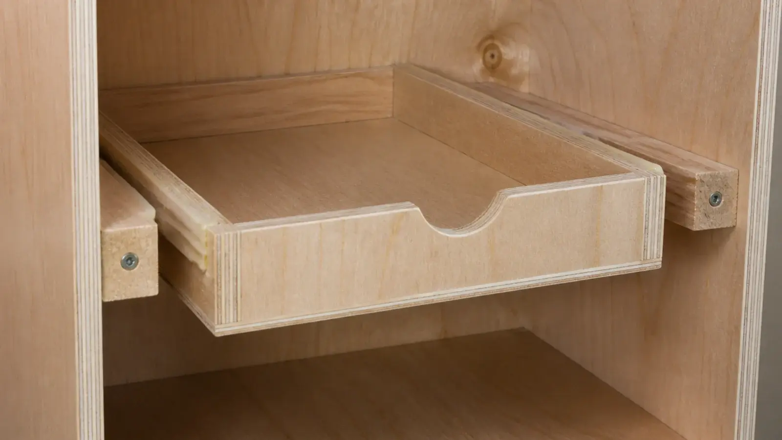 wooden cleats screwed inside a cabinet carrying a simple sliding drawer