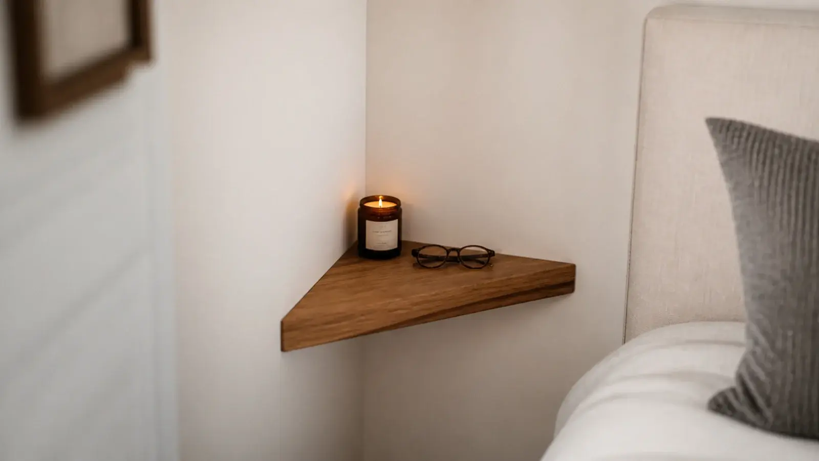 triangular floating shelf mounted into a bedroom wall corner
