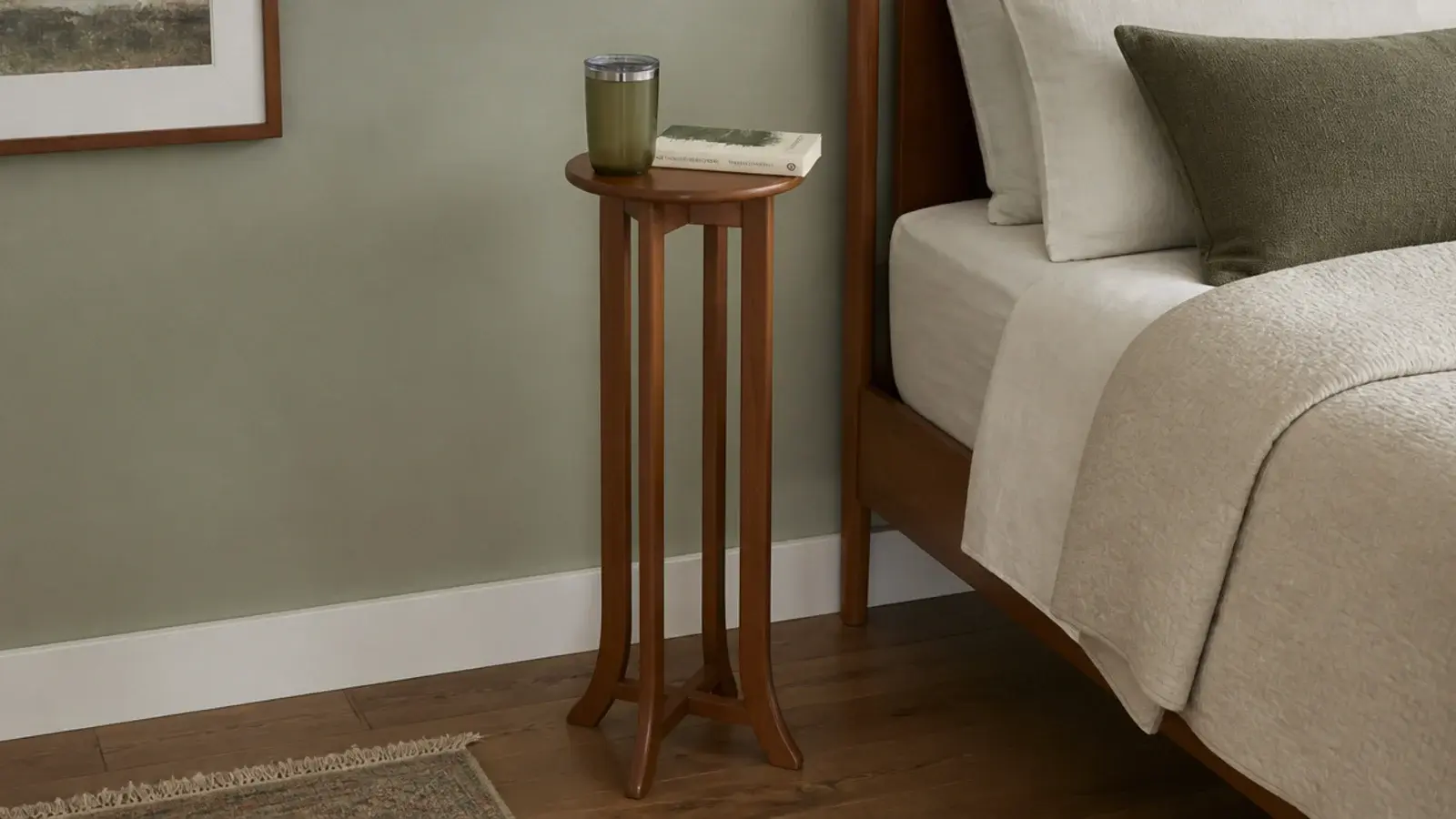 narrow eight inch plant stand repurposed as a tiny bedside surface