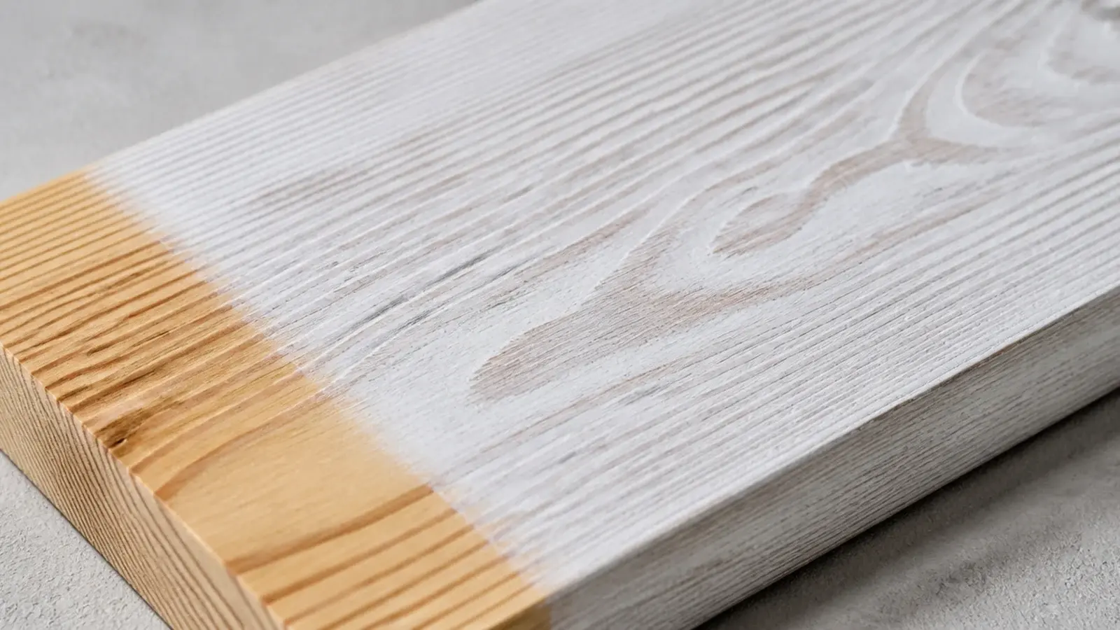 limewashed pine surface with grain visible through a chalky white film