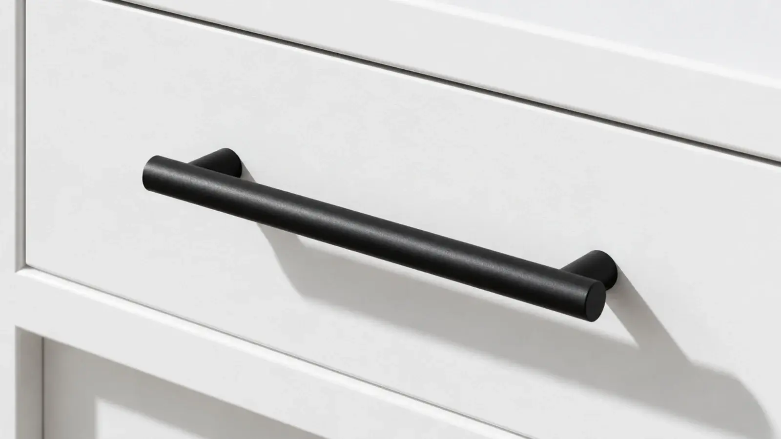 slim black bar pull mounted across a plain white drawer front