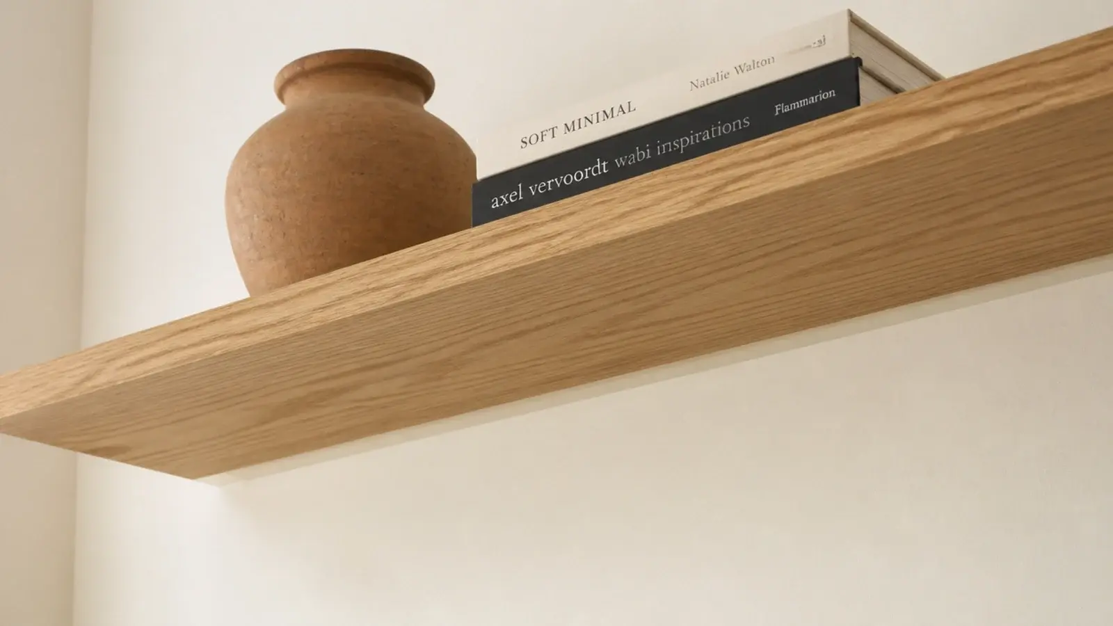 shelf brackets painted the wall color and visually disappearing beneath boards