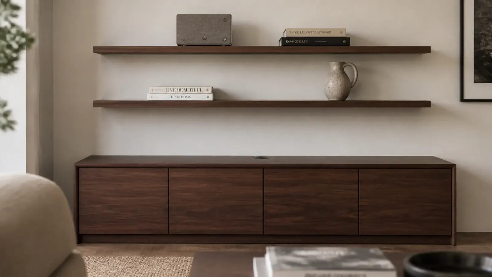 slim floating shelves above a closed walnut media cabinet with speaker and books