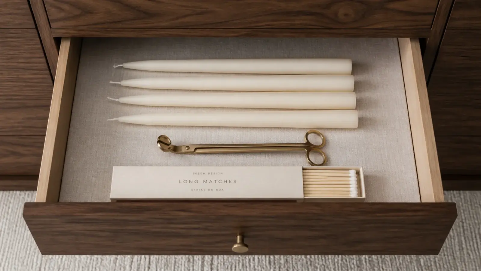 spare ivory tapers stored flat in a drawer lined with linen cloth