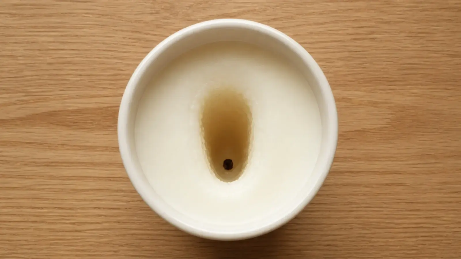 deeply tunneled candle with thick wax walls and a drowning wick