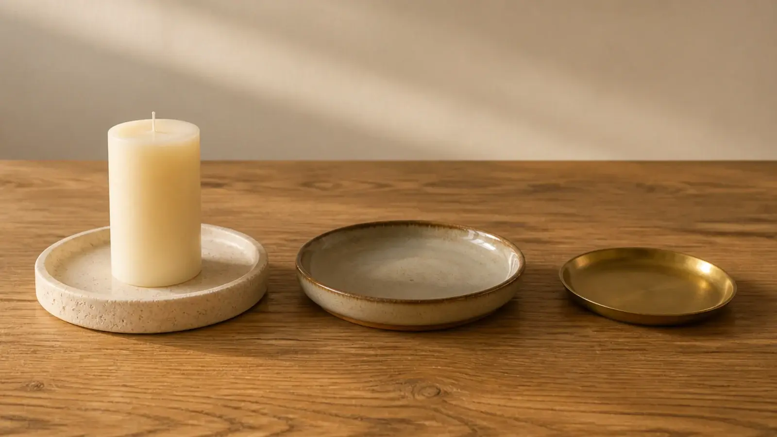 stone tray and ceramic dish compared beside a bare oak tabletop