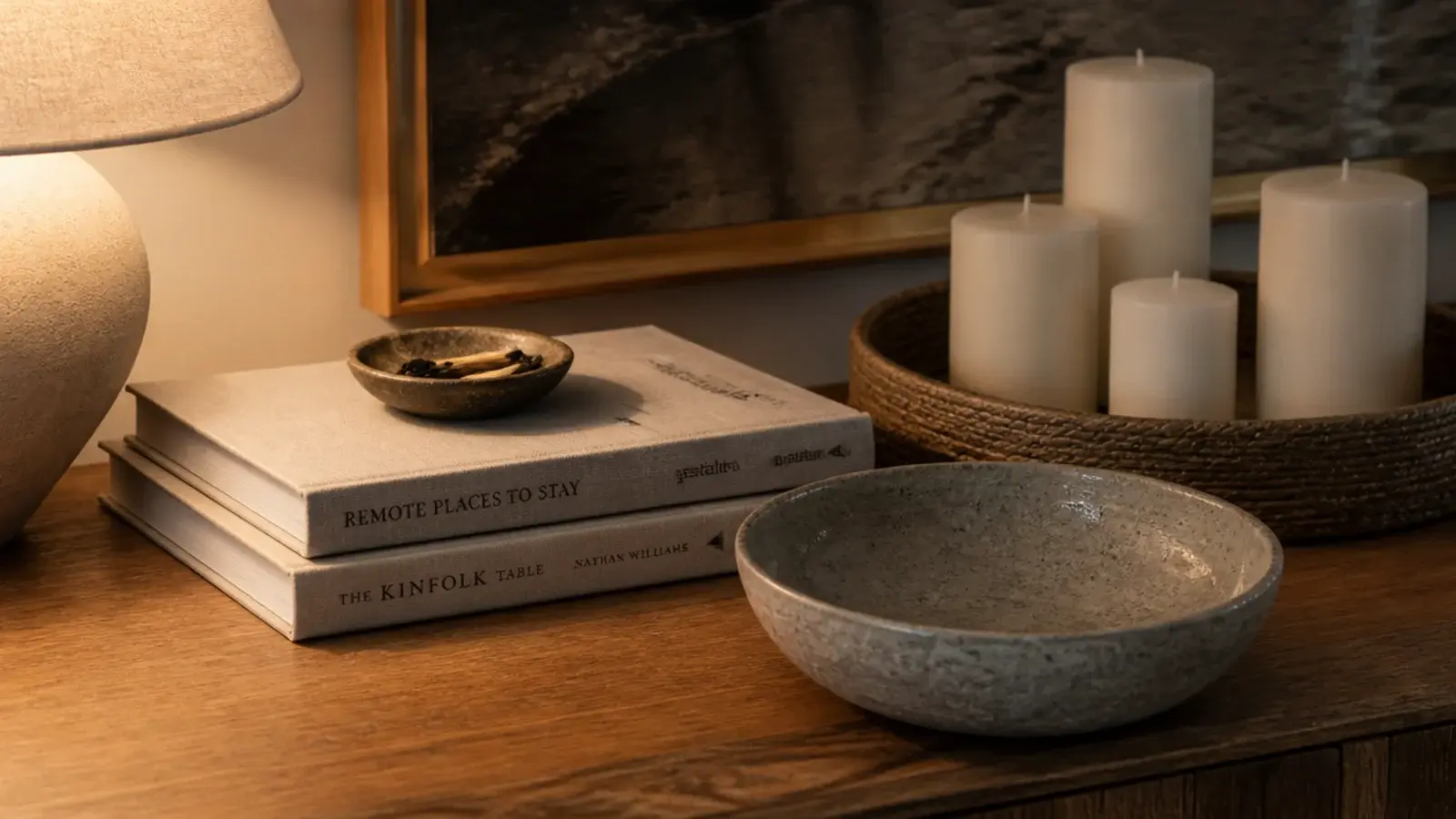 stack of two books anchoring a candle grouping on a wooden tray