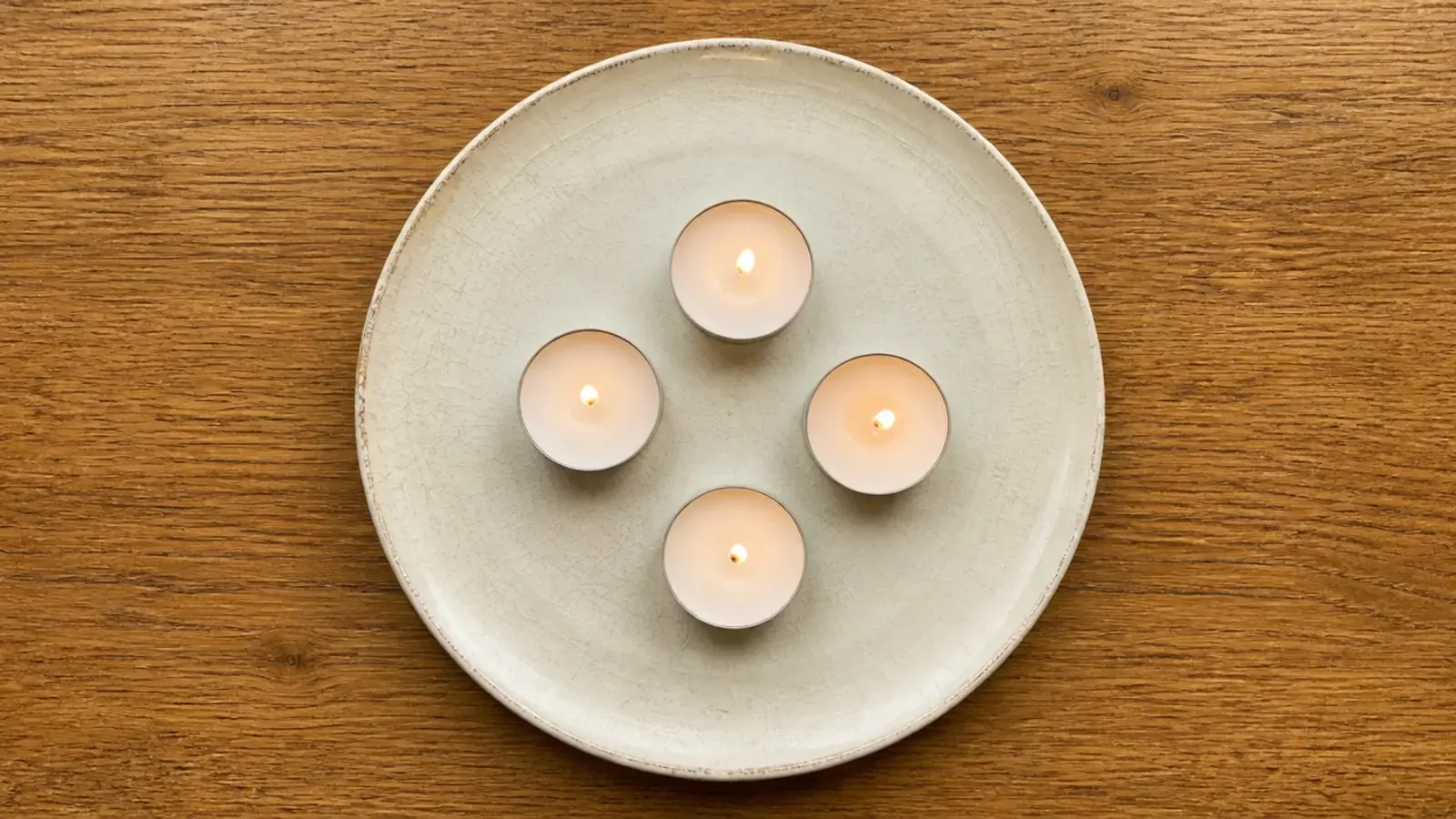 chipped vintage ceramic plate used as a budget candle tray with tealights