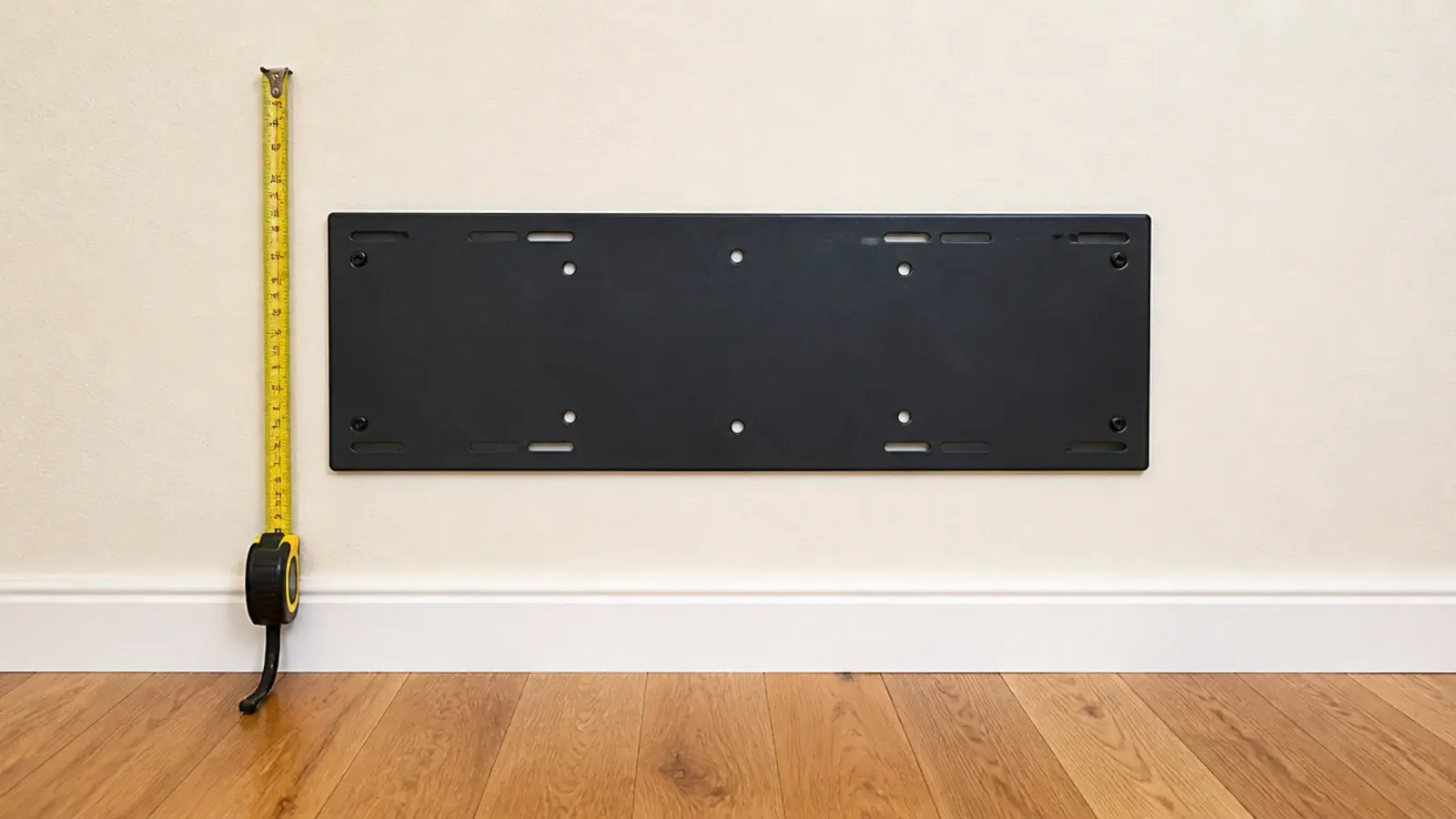 metal backplate mounted on a plaster wall ready for candle wall decor