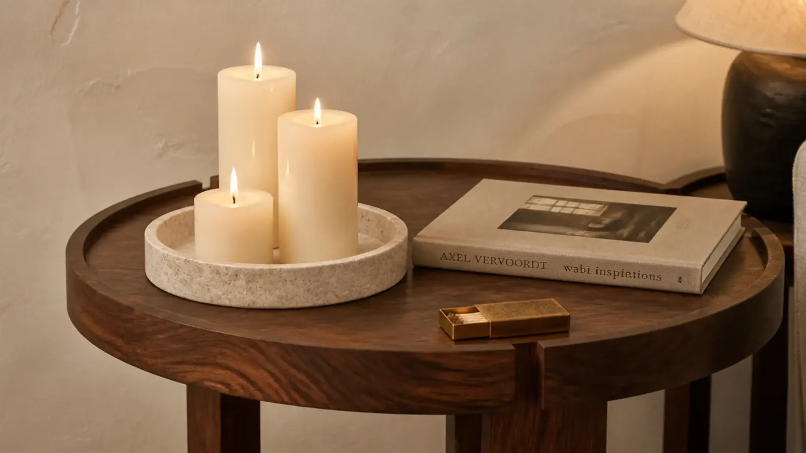 stone tray on a side table holding three candles at stepped heights