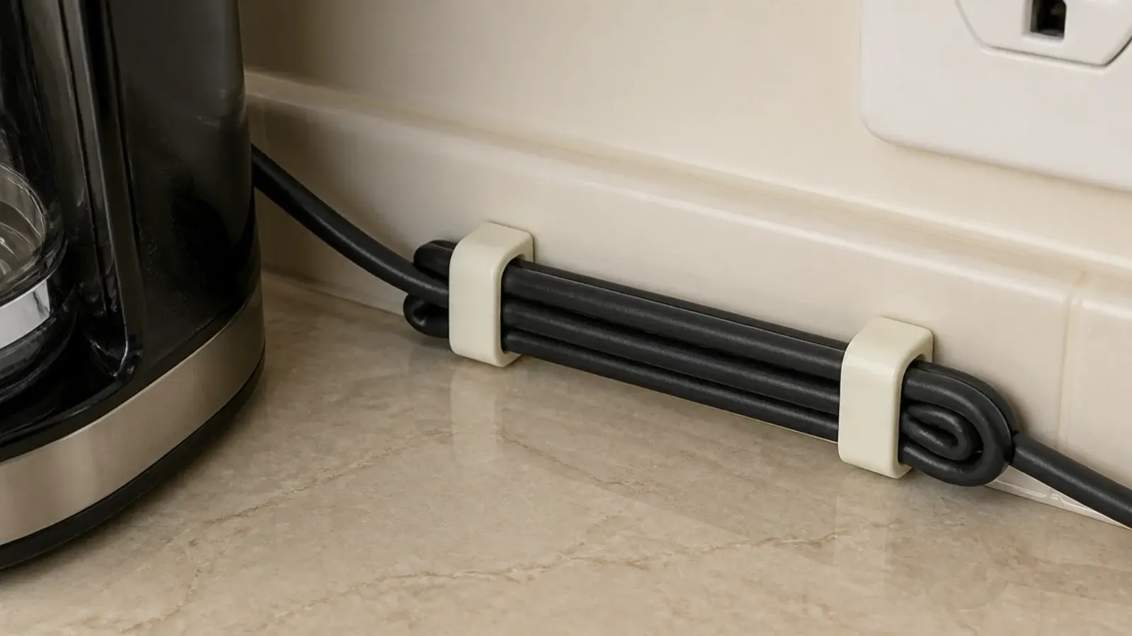appliance cord clipped along the back edge of a coffee bar counter