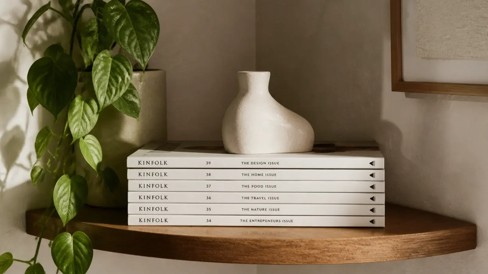 neat stack of magazines used as a plinth under a small sculpture