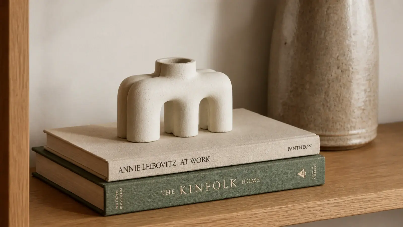 small sculptural object raised on two hardbacks lying flat on a shelf
