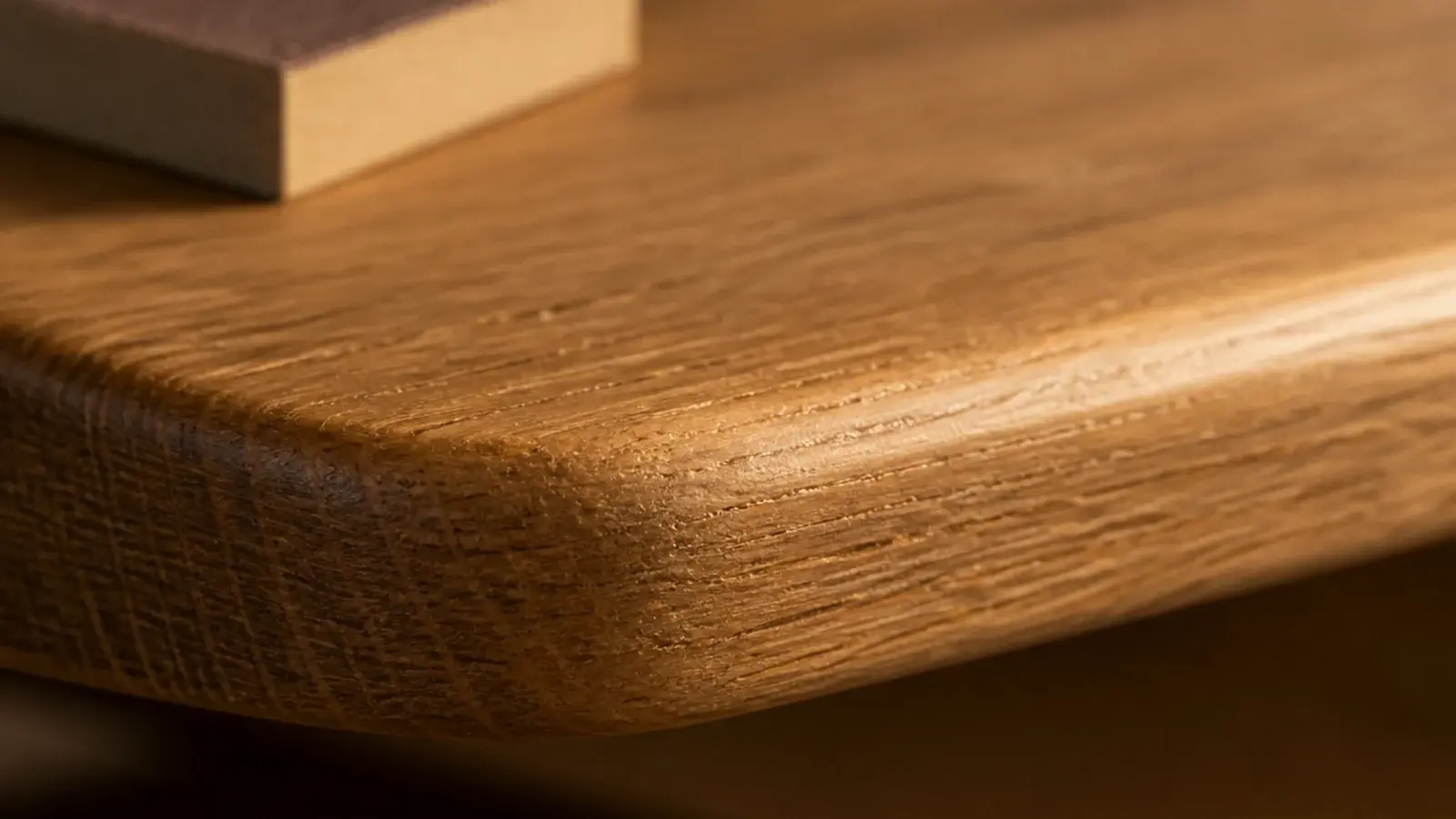 thumb-width rounded front edge on a sanded oak corner shelf board