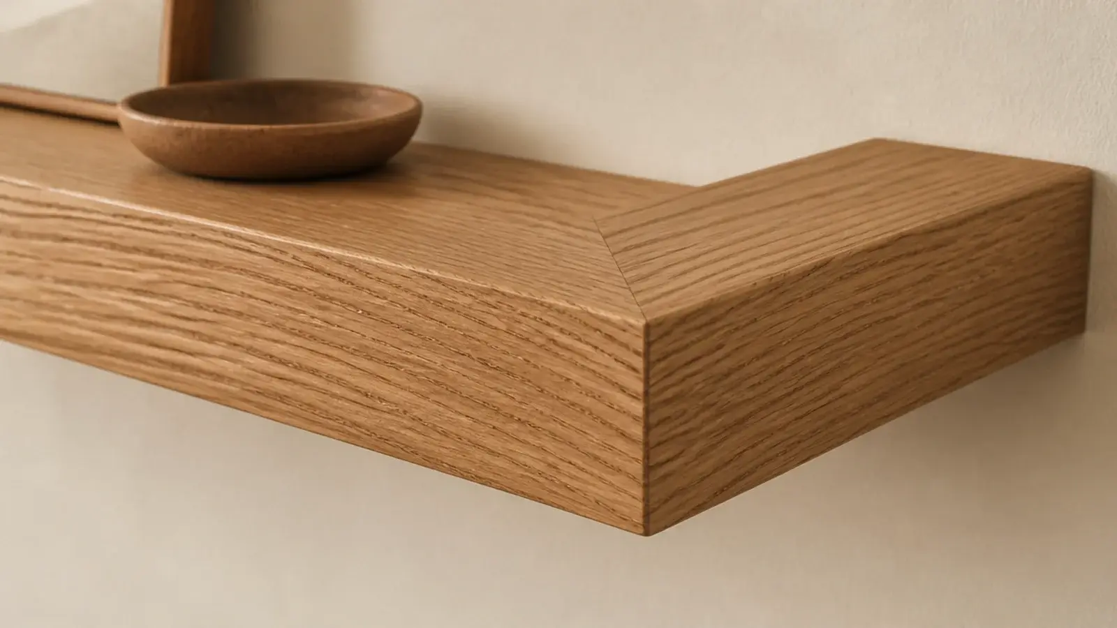 L shaped floating shelf with a clean mitered corner joint in oak