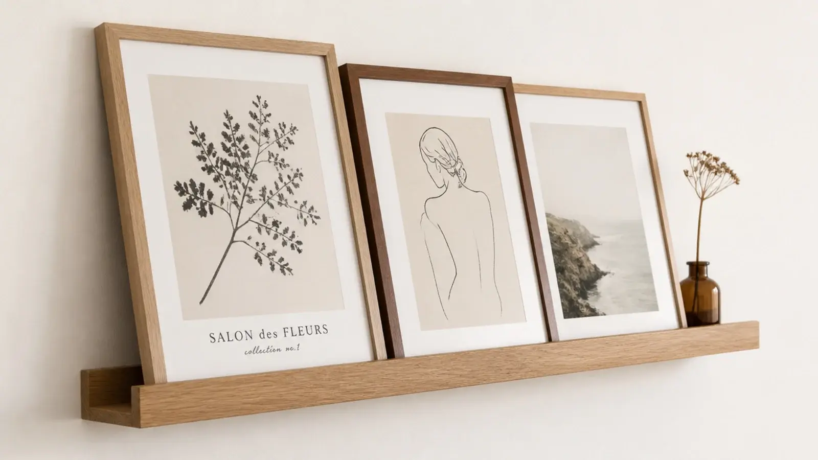 floating corner shelf with a raised front lip holding leaning prints
