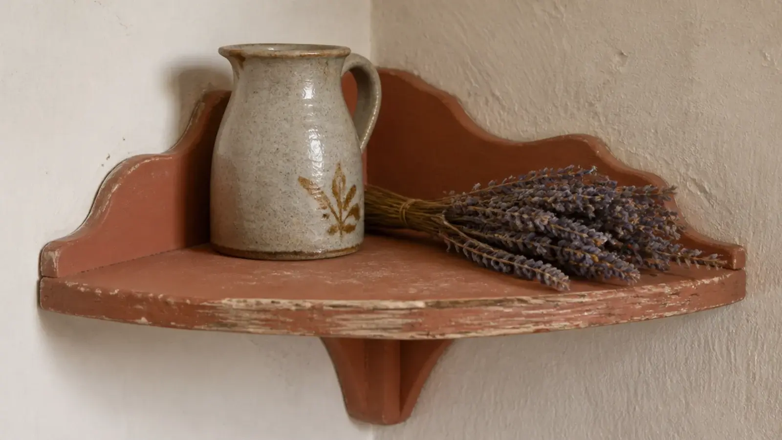 chalky milk painted rustic shelf with natural wear along the front edge