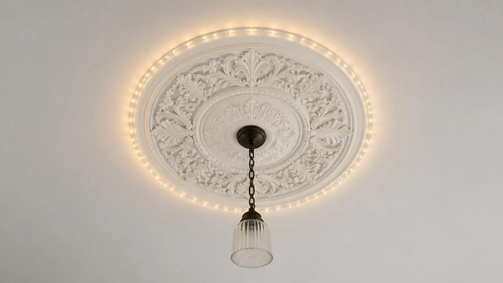 lights circling a plaster ceiling rose around an unlit pendant