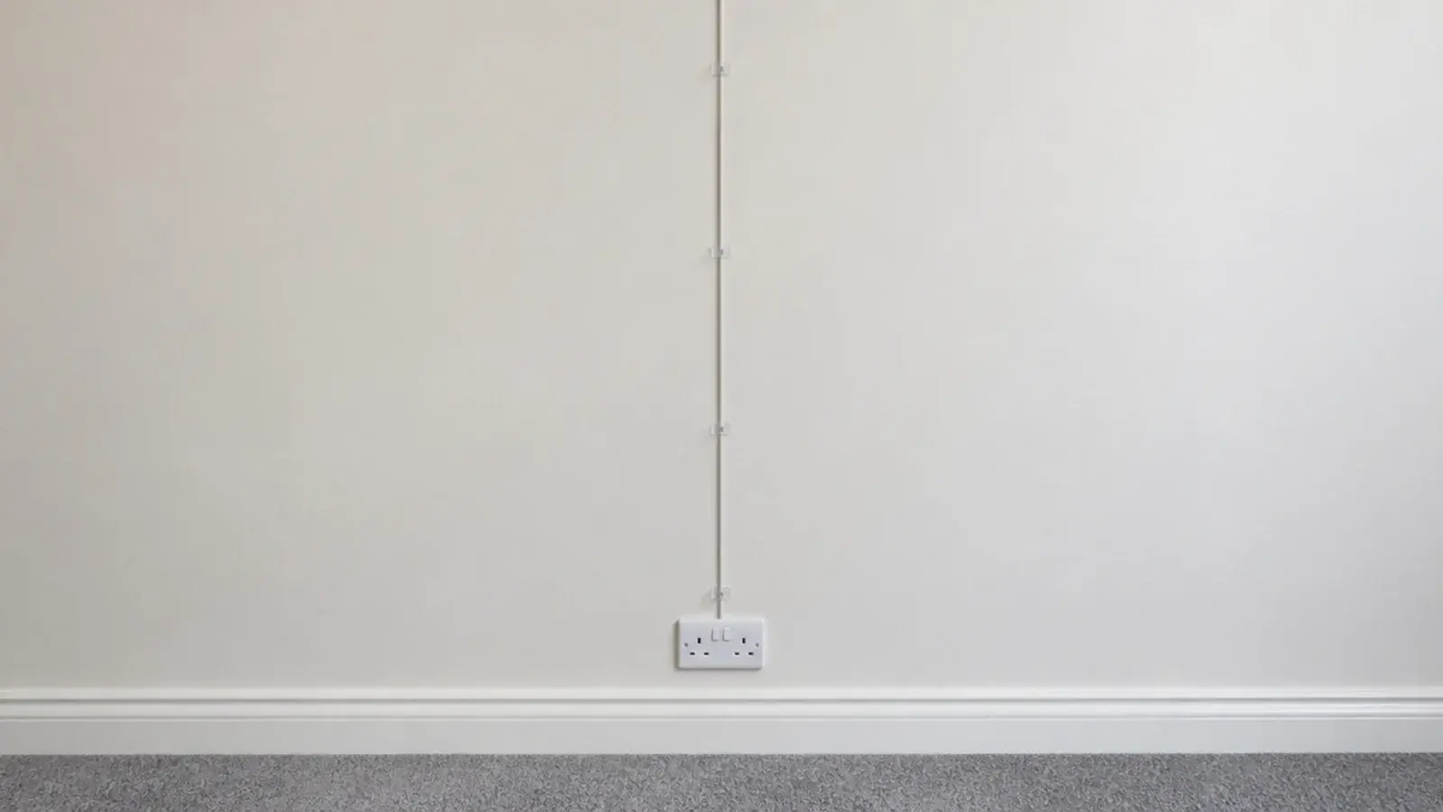 light lead clipped in a straight line down a painted bedroom wall