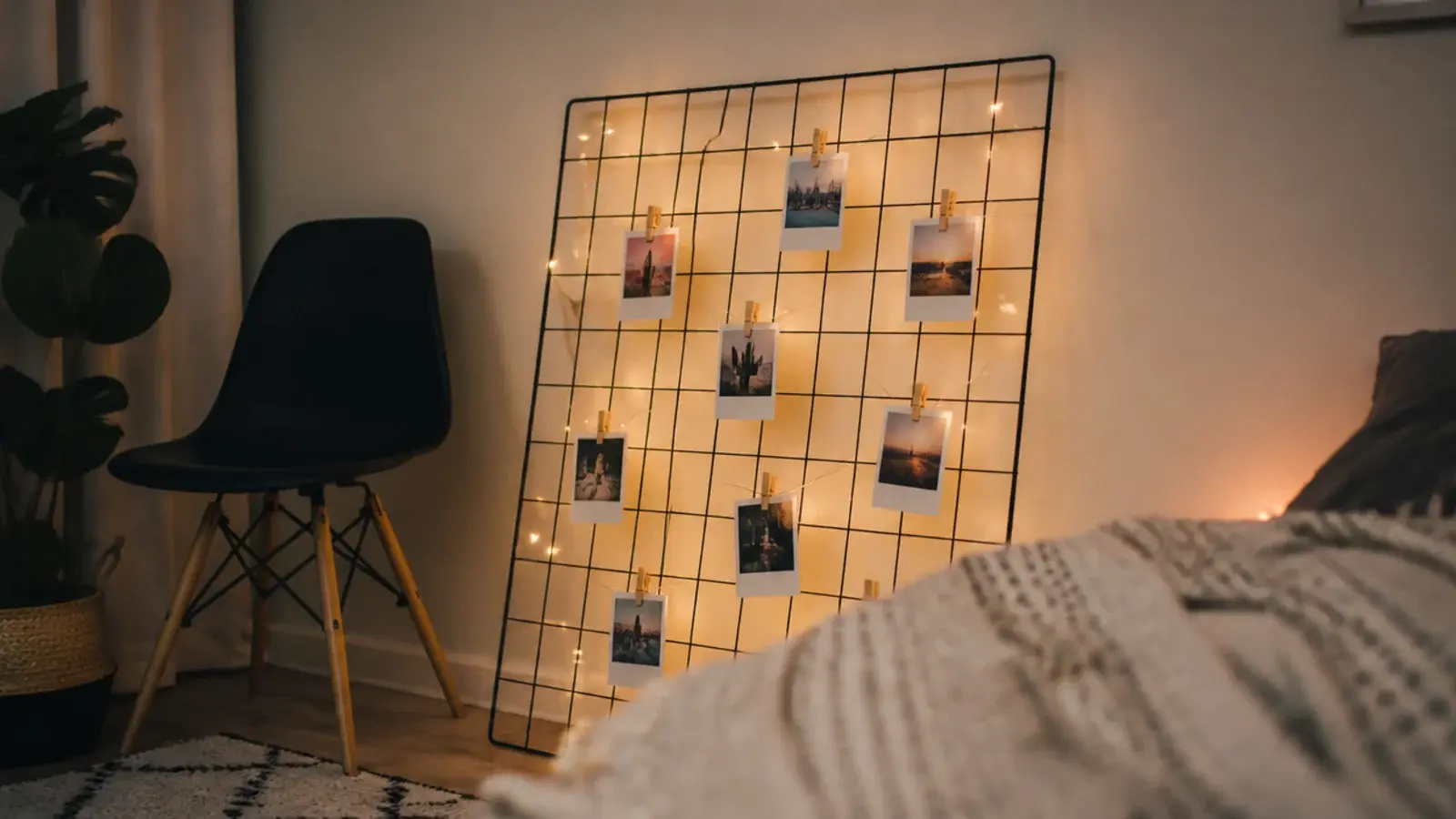 metal grid panel on a wall with lights woven through the mesh