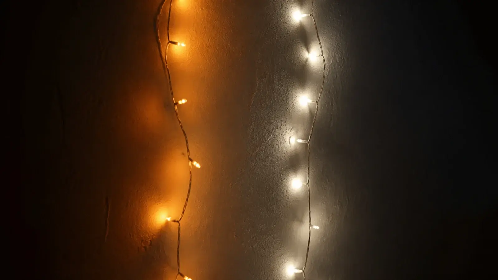 two strands lit side by side showing different warmth on plaster