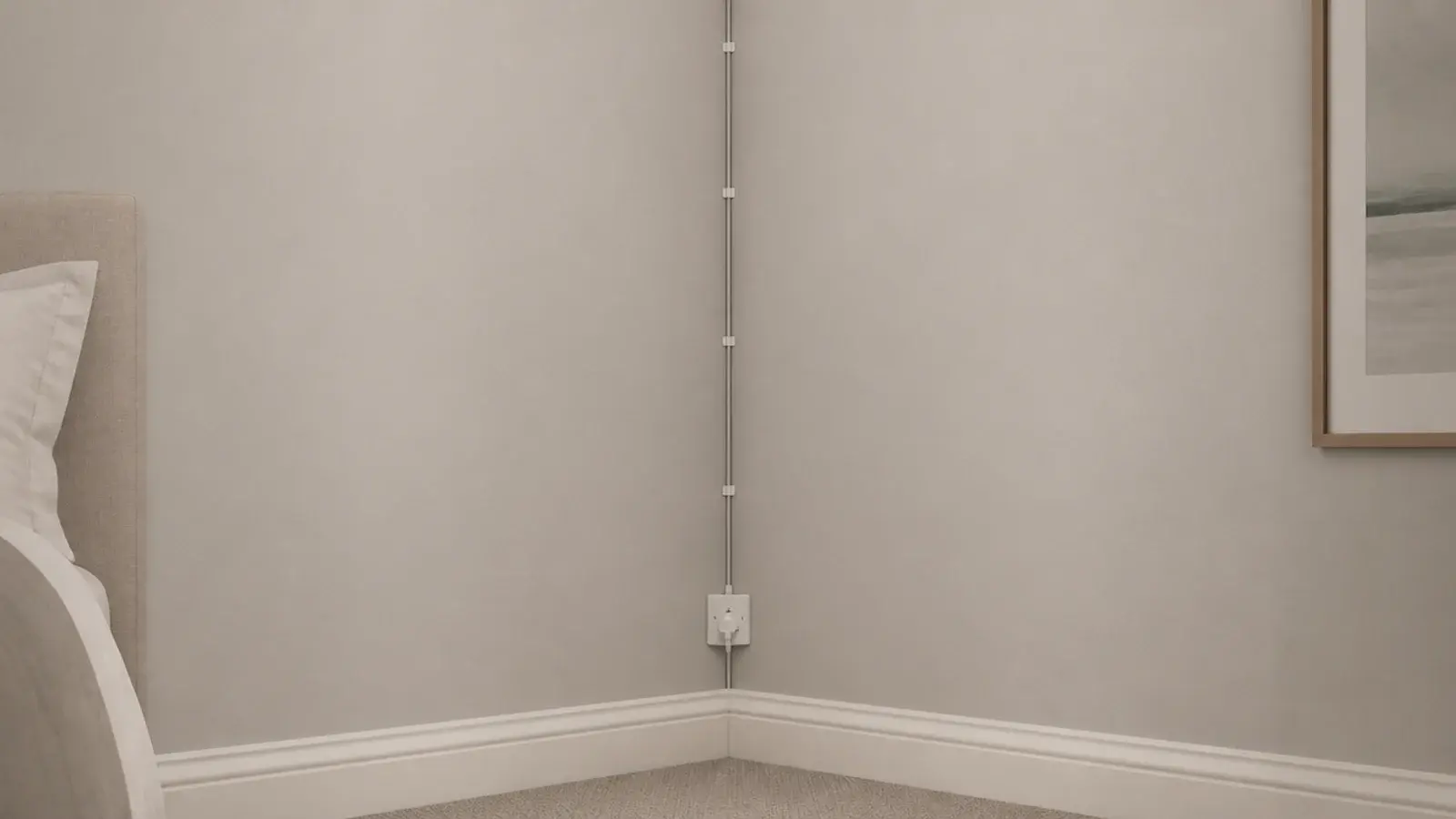 cable clipped straight down a wall corner toward a socket