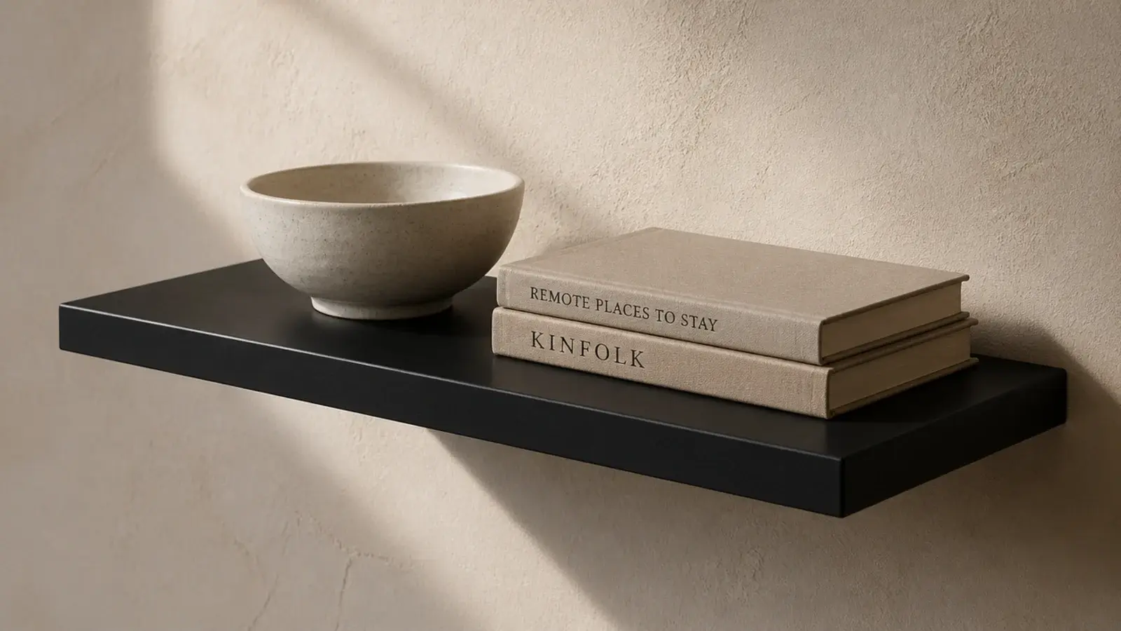 single matte black shelf sharp against a warm cream plaster wall