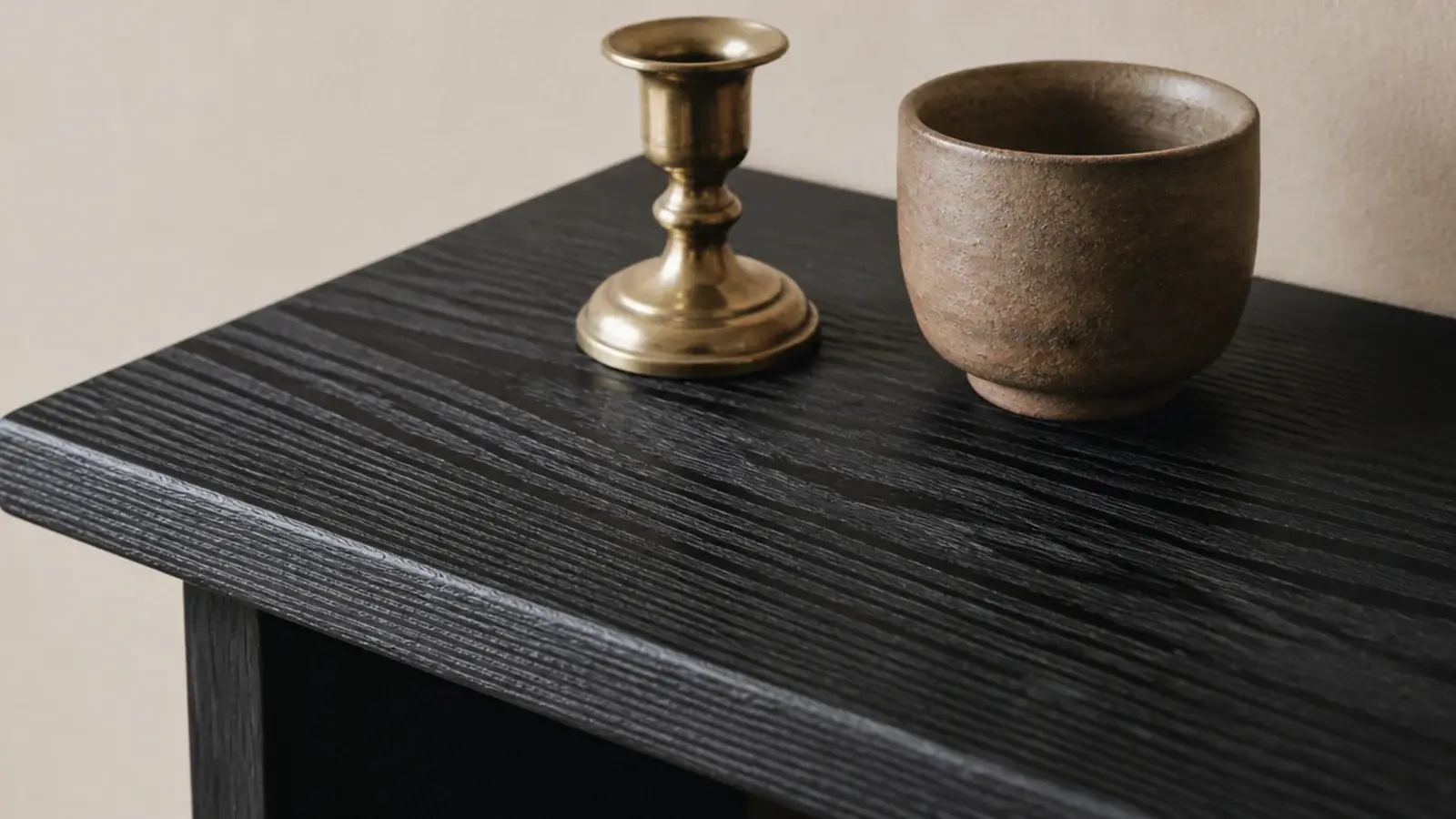 black stained oak shelf showing visible grain under a dark finish