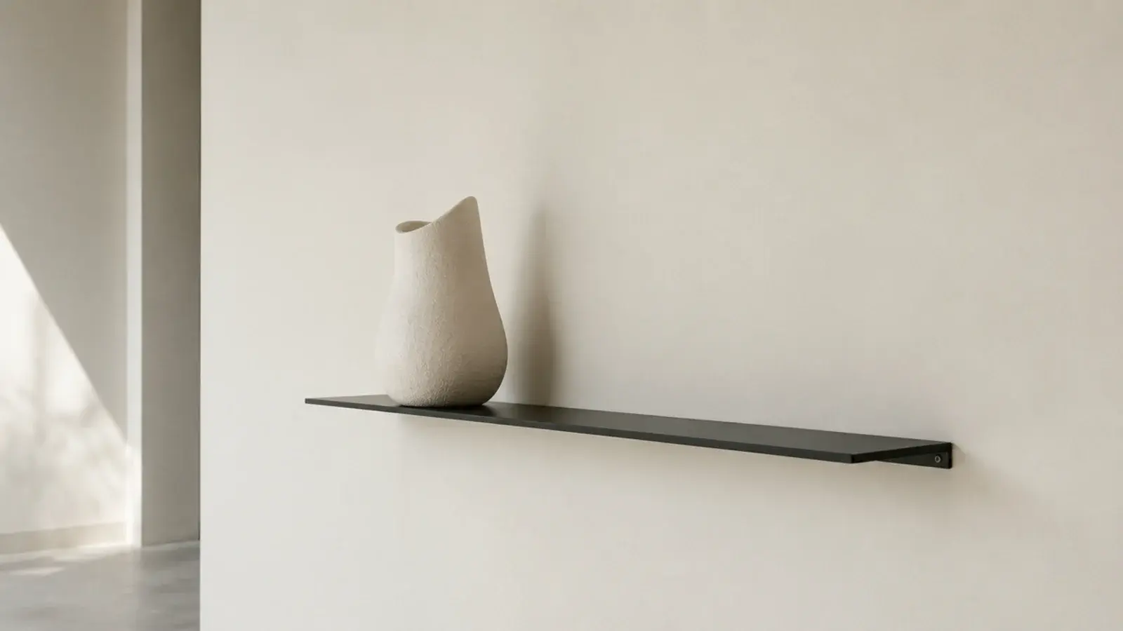 quarter inch black steel plate shelf reading as a thin dark line