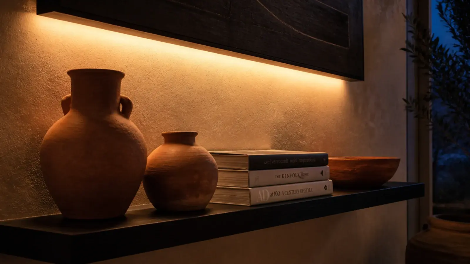 warm led strip glowing under a black shelf lighting objects below