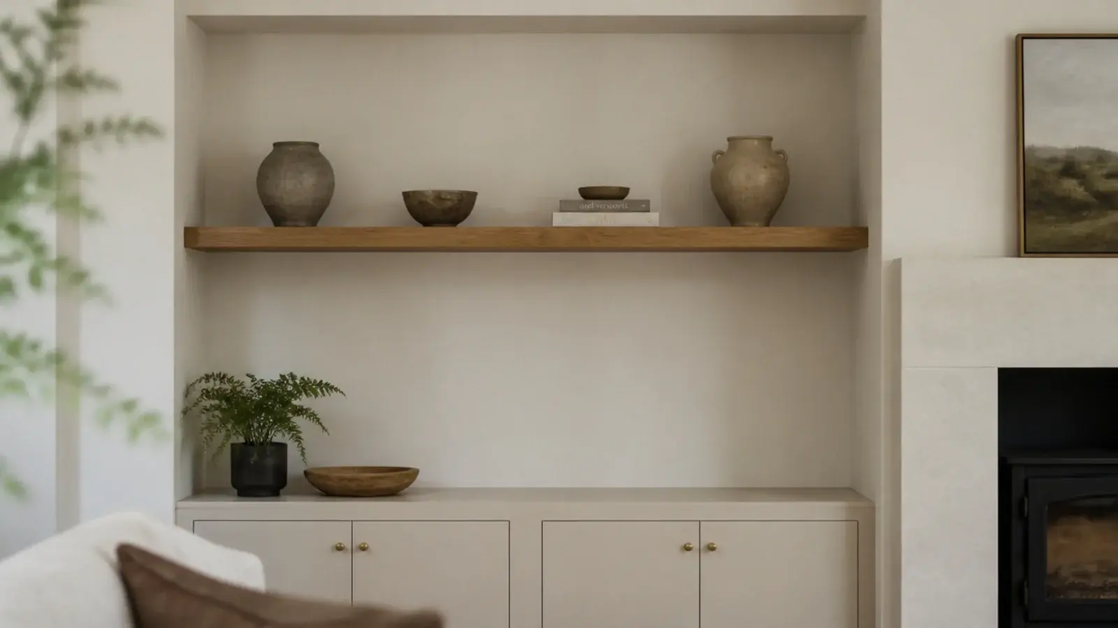 floating shelf spanning an alcove wall to wall above a low cabinet